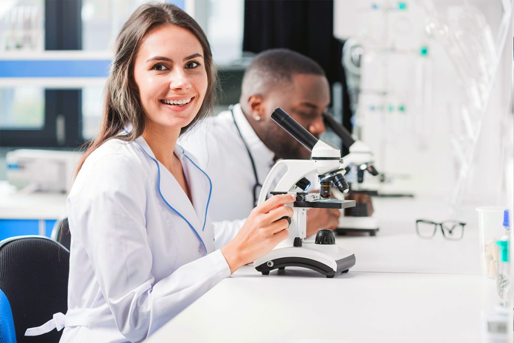 smiling doctor microscope